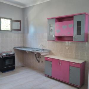 a kitchen with a sink and a stove at Habou City Apartment in Luxor