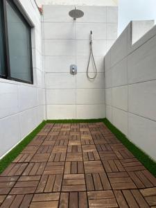 a bathroom with a shower with a tile floor at ENZO SUITE in Las Palmas de Gran Canaria