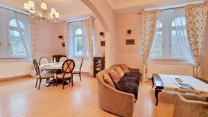 a living room with a couch and a table at Luxury apartment Diamond in Karlovy Vary