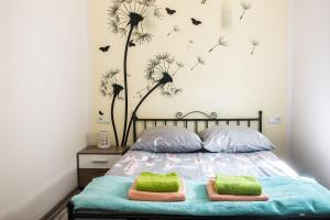 a bedroom with a bed with dandelions on the wall at Natalia Rest domki & camp in Tałty
