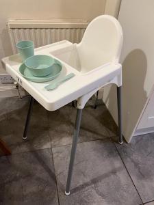 a white table with bowls and plates on it at Victorian 3 BR main door flat, King size beds , large rooms in Glasgow