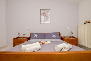 a bedroom with a bed with towels on it at City Melody Apartment with Private Parking in Alexandroupoli