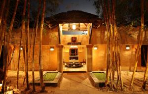 a lobby of a building with trees in front of it at Tuli Tiger Resort in Dhanwār