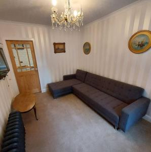 a living room with a couch and a table at Lovely 1 Bed house in Largs, North Ayrshire in Largs