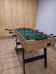 a foosball table with a group of cues on it at Apartamenty Słodyczki in Nowe Bystre