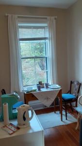 a living room with a table and a window at Sea Birds Cottage in Victoria