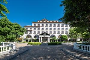 a large white building with a courtyard and trees at Lakeshore Hotel Hsinchu in Hsinchu City