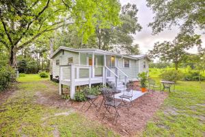 a tiny house with a table and chairs in the yard at Cozy OBrien Home with Fire Pit and Patio Near Rivers! in Branford