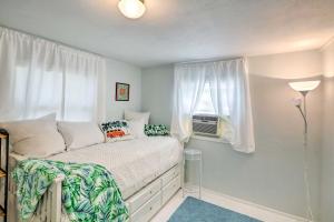 a small bedroom with a bed and a window at Cozy OBrien Home with Fire Pit and Patio Near Rivers! in Branford