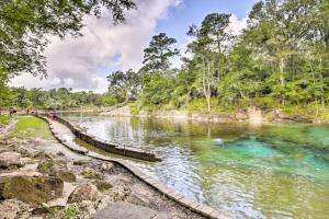 a river with people walking on the bank at Cozy OBrien Home with Fire Pit and Patio Near Rivers! in Branford