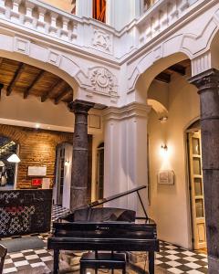 a piano sitting in the middle of a building at Carlota Sustainable Design Hotel in Quito