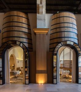 a restaurant with two wine barrels on the wall at H&ocirc;tel Chais Monnet & Spa in Cognac