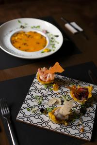 a plate of food on a table with a plate of food at Carlota Sustainable Design Hotel in Quito