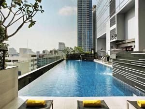 a large swimming pool on the roof of a building at Novotel Bangkok Ploenchit Sukhumvit - SHA EXTRA PLUS in Bangkok