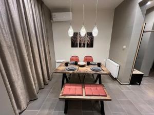 a dining room with a table and chairs at Supreme City Heart Suites in Alexandroupoli