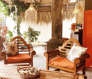 a living room with two chairs and a table at The Hideaway Canggu in Canggu