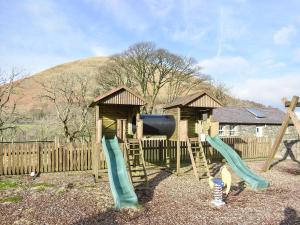 a playground with two slides and a play structure at Mount Cottage-uk42230 in Low Borrowbridge