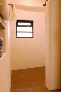 baño con ventana y suelo de baldosa en Villa 19 habitación #2 en Guanajuato