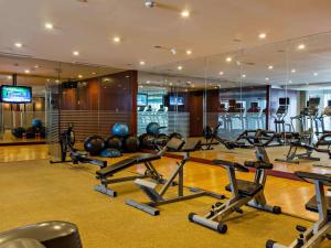 a gym with a lot of treadmills and exercise bikes at Joy-Nostalg Hotel & Suites Manila Managed by AccorHotels in Manila