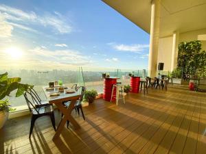 a balcony with a table and chairs and a view at Joy-Nostalg Hotel & Suites Manila Managed by AccorHotels in Manila