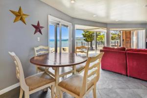 a dining room with a table and chairs and a red couch at Private Beach, Pool Table, Close To Everything in South Lake Tahoe