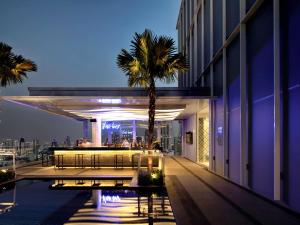 a view of a building with a palm tree at Mercure Bangkok Sukhumvit 24 in Bangkok