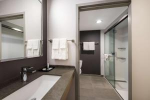 a bathroom with a tub and a sink and a shower at Sonesta Select San Jose Airport in San Jose