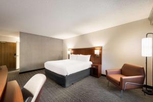 a hotel room with a bed and a chair at Sonesta Select San Jose Airport in San Jose