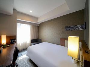 Postel nebo postele na pokoji v ubytování ibis Styles Tokyo Ginza