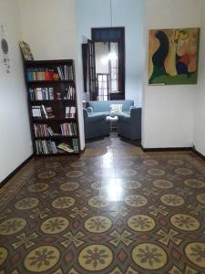 a living room with a couch and a book shelf at Casa Quinta in Colonia Caroya