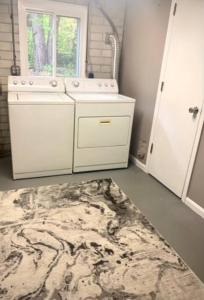 a bathroom with a sink and a rug on the floor at E. Turkeyfoot Whole House in Akron