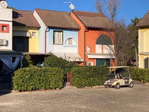a small car parked in a parking lot in front of houses at Apartment in Albarella 42379 in Palazzo Vianello