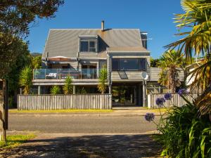 a house on the side of the road at Pohara Beach Escape - Pohara Beach Holiday Home in Pohara