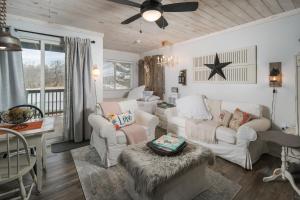 a living room with two white couches and a table at 2026 Schedule OPEN, Walk to SKI SHUTTLE! Beech Mtn Winter Concert Series! in Beech Mountain