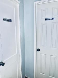 two white doors next to each other in a room at The Doze Off in Houston