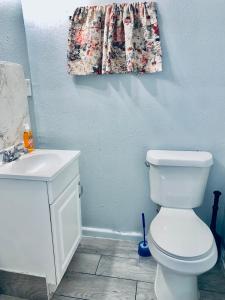 a bathroom with a white toilet and a sink at The Doze Off in Houston