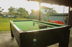 a pool table with a ball on top of it at Pousada do Dinho in Esmeraldas