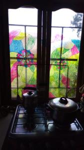 two pots on a stove in front of a window at Casa Amaranta in Samaipata