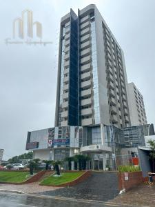 a large building in front of a street at American Flat - Ponta D'areia - Ferreira Hospedagens in São Luís