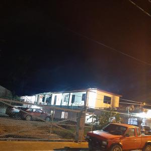 un camión estacionado frente a una casa por la noche en B&B KeisyAlba Punta Rucia, en Punta Rucia