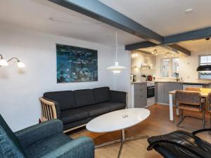 a living room with a couch and a table at 4 person holiday home in Rudkøbing-By Traum in Rudkøbing