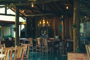a dining room with chairs and tables in a building at Pousada Chalés do Rancho Canastra in Vargem Bonita