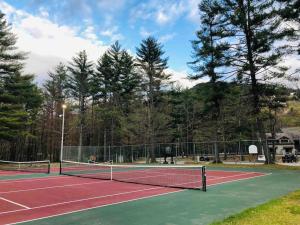 a tennis court with a net on top of it at Attitash Mountain Village Studio - Slope View - Ski - NEWLY RENOVATED in Bartlett