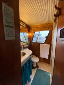 a small bathroom with a toilet and a sink at The Lily Pad Boatel Houseboat in Savanna