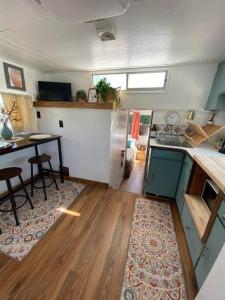 a kitchen and living room with a table and a counter at Unique and Serene Sunset Houseboat for 4 in Savanna
