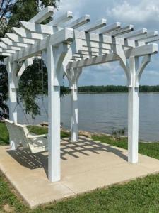 a white pergola sitting next to a body of water at Unique and Serene Sunset Houseboat for 4 in Savanna