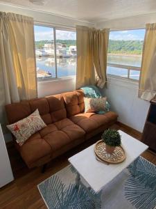 a living room with a couch and a table at Unique and Serene Sunset Houseboat for 4 in Savanna