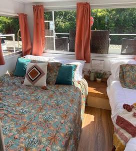 a room with two beds and a couch and a window at Unique and Serene Sunset Houseboat for 4 in Savanna