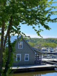 a house on a dock with a marina with boats at Floating Cottage on the River Nantucket in Savanna