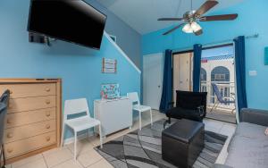 a living room with a flat screen tv on the wall at Sugar Beach 304 condo in Gulf Shores